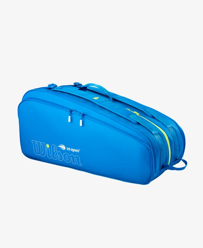 Blue wilson open tour tennis bag that holds 12 rackets. Vibrant yellow pops of color