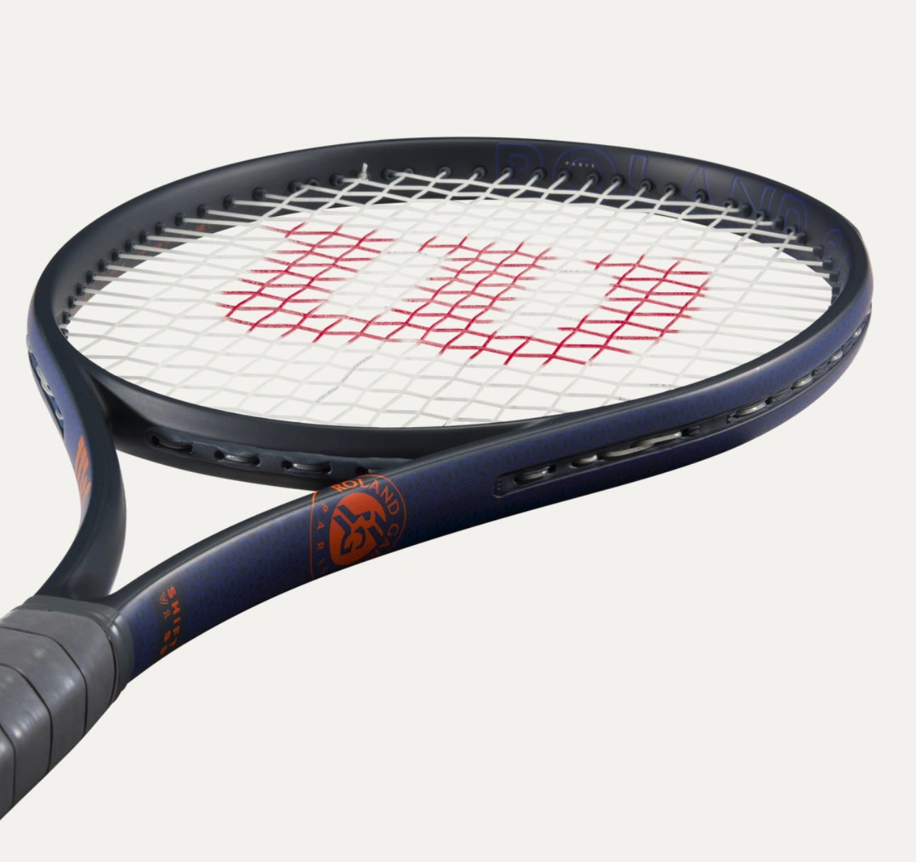 Tennis racket with a blue frame and red strings on a white background
