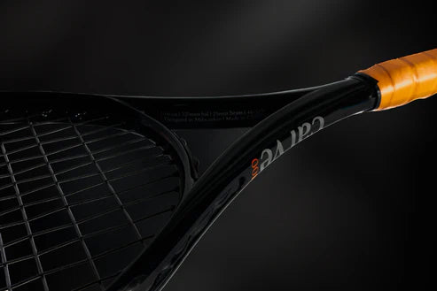 side close up view of carve 100 all court tennis racquet black frame with faux leather handle